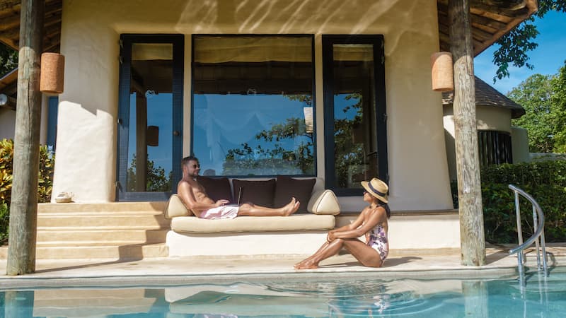 A Happy Couple poolside at their home in Costa Rica